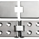 Realizzata in acciaio inox AISI 316 lucidato a specchio. Applicabile per tavoli o portelli con apertura a ribalta.Dotata di cover copriviti applicabile dopo il montaggio per un design pulito e lineare.